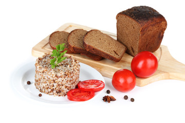Buckwheat in plate with bread and vegetables isolated on white