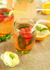Basil lemonade with strawberry in  jug and glass,