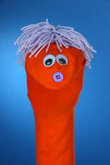 Cute sock puppet on blue background