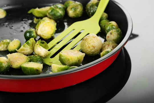 Fresh brussels sprouts in pan on cooking surface close-up