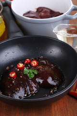 Raw liver in pan on cooking surface close-up