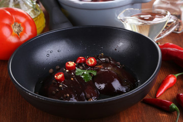 Raw liver in pan on cooking surface close-up