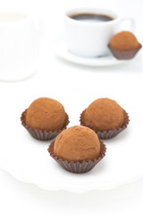 chocolate truffles and a cup of coffee on a white background