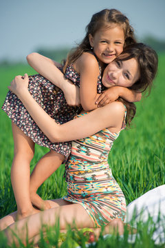 Happy girls on green grass. Playing