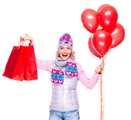 Happy american woman with red shopping bags  and balloons