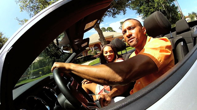 Successful African American Couple Driving Open Top Cabriolet