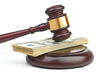 Law gavel on a stack of American money.