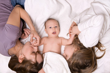 Mom, daughter and son lying in bed