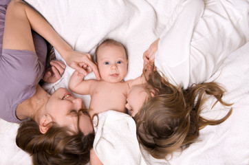 Fototapeta na wymiar Mom, daughter and son lying in bed