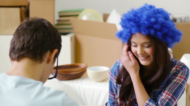 Girl wearing blue wig and guy with huge eyes