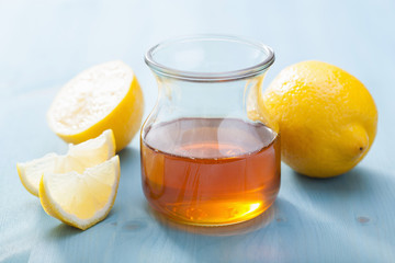 honey and lemon over blue background