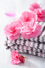 pink flowers and towel for spa