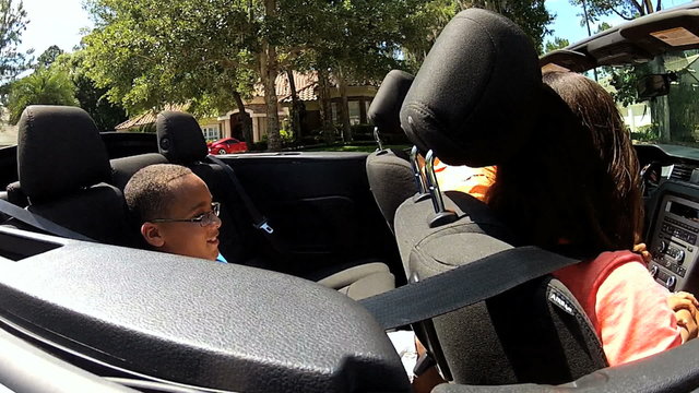 Successful African American Family Driving Open Top Cabriolet
