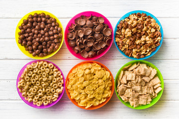various kids cereals in colorful bowls