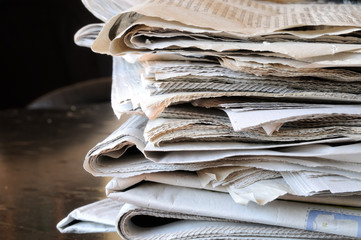 stack of newspapers on table