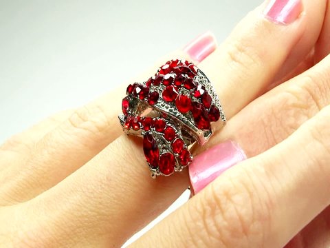 jewelery ring with red ruby crystals purring on the finger
