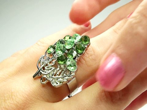 jewelery ring with green emerald crystals purring on the finger