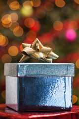 Blue gift box under a Christmas tree