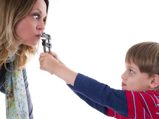 Naughty child does not allow his nervous mother to talk - young 