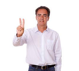 Adult hispanic man with victory sign