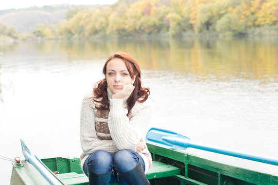 Pretty Young Woman Sitting In A Rowboat