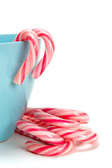 striped Christmas candy in a blue cup