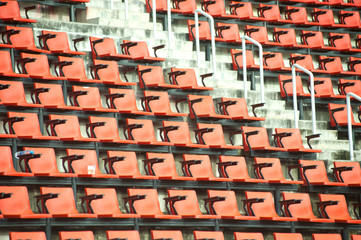 Row of orange seats in stadium.