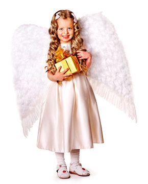 Child at angel costume holding gift box.