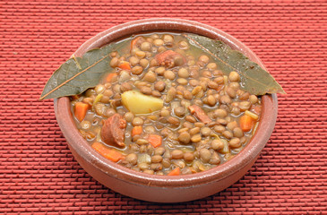 Brown lentil stew in bowl with vegetable