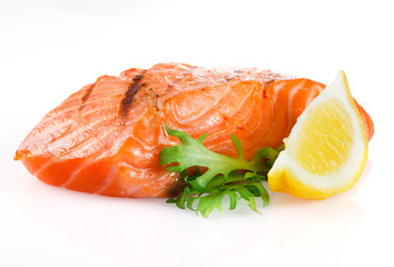 Grilled salmon with lemon on white background