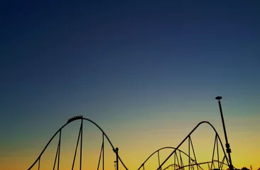 Ingelijste posters Roller coaster against setting sun © jefftakespics2