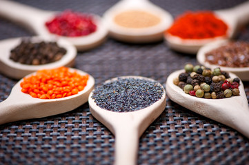Various kind of spices on wooden spoon -  detail of poppy seeds