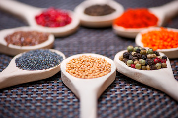 Various kind of spices on wooden spoon -  detail of mustard seed
