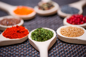 Various kind of spices on wooden spoon -  detail of parsley