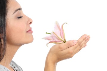 Close up of a beautiful woman profile smelling a pink flower - obrazy, fototapety, plakaty