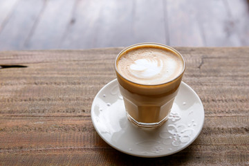 hot coffee on grunge wood background