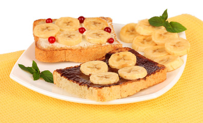 Delicious toast with bananas on plate close-up