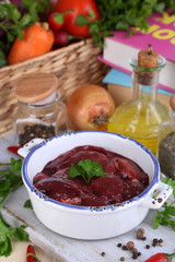 Raw liver in pan with spices and condiments