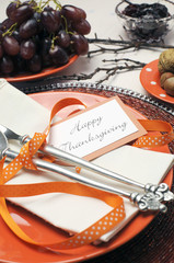 Thanksgiving orange polka dot table setting. Close up.