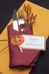 Happy Halloween table place setting with red and orange napkins
