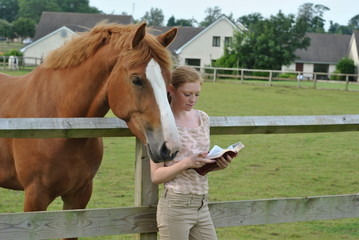 Student studying Holy Bible on Farm with Horses