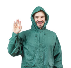 Caucasian man in hooded rain suit waiving with palm isolated on © snyfer