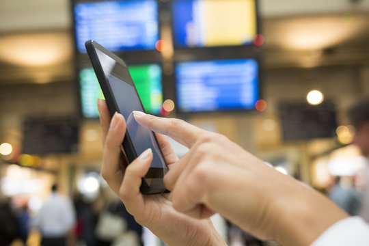 Close up of hands woman using her cell phone in station, backgro