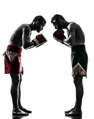 two men exercising thai boxing salute  silhouette