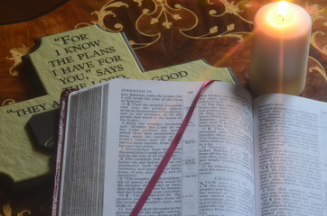 Holy bible cross by candlelight