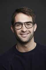 Portrait of mid adult man in glasses, smiling