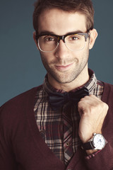 Charming old-fashioned male correction his bow tie