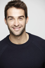 Fototapeta premium Portrait of mid adult man against grey background