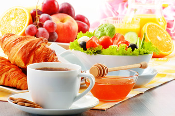 Breakfast with coffee, orange juice, croissant, egg, vegetables