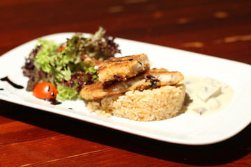 Close image of business lunch rise with fish and salad